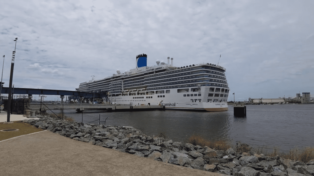 Carnival Luminosa docked in Brisbane under cloudy skies, ready for its next cruise adventure.