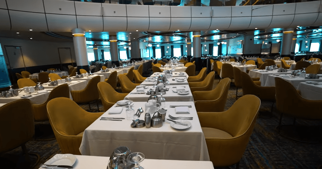 Elegant dining room aboard Royal Caribbean's Spectrum of the Seas with luxurious decor and tables set for guests