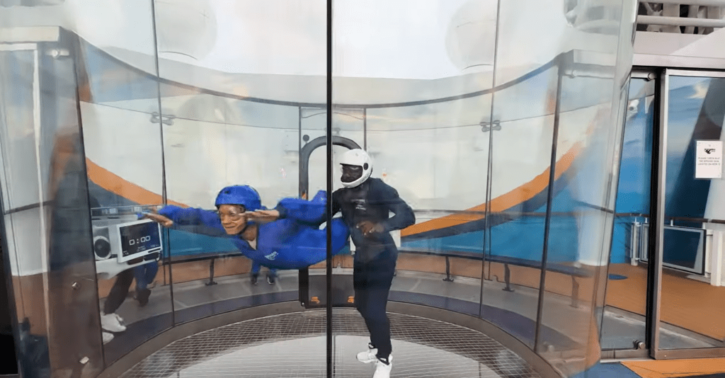 Person enjoying an indoor skydiving experience at RipCord by iFly on Royal Caribbean's Spectrum of the Seas.