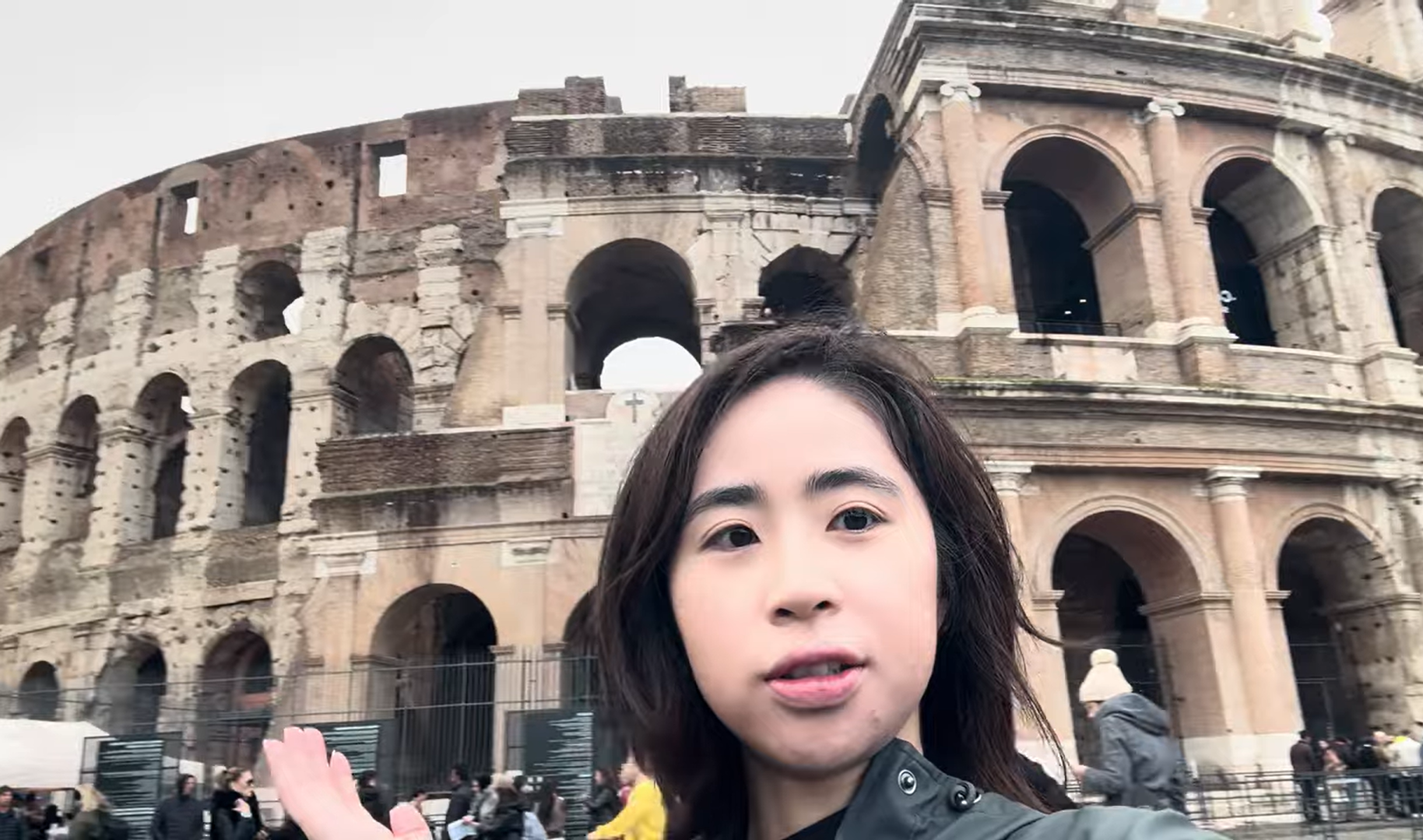 Eyvonne Chen standing in front of the Colosseum in Rome, capturing the iconic ancient landmark during her solo European adventure.