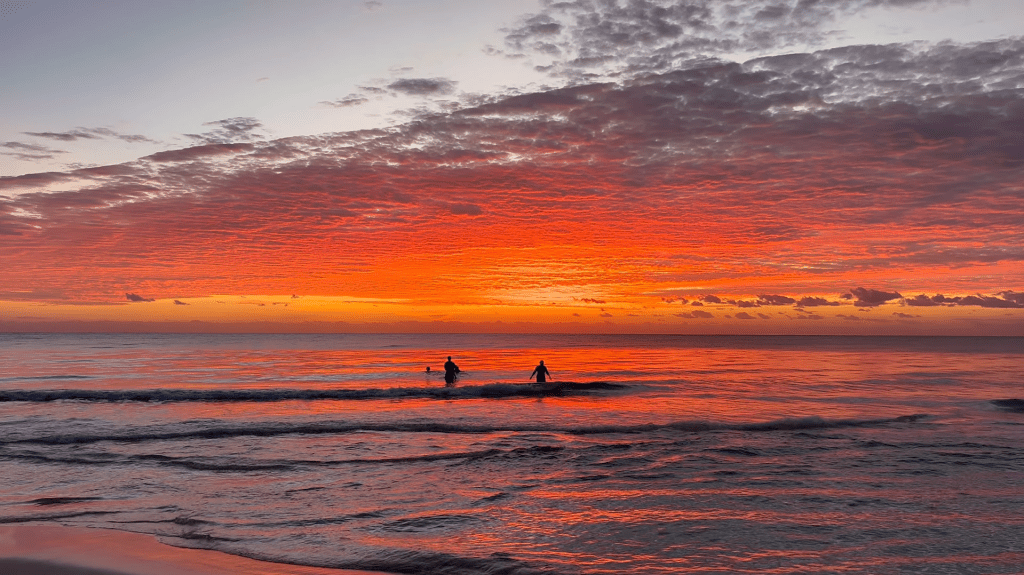 Vibrant sunset over the beach in Tulum.