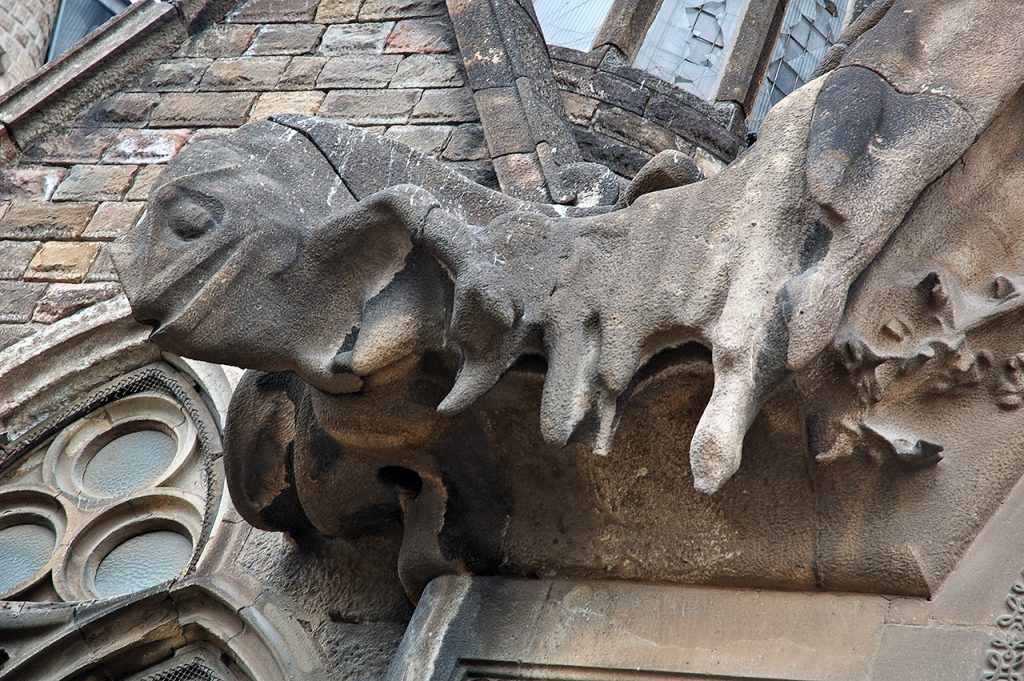 Close-up of a chameleon sculpture on the Nativity Façade of La Sagrada Família, symbolizing transformation and adaptability.