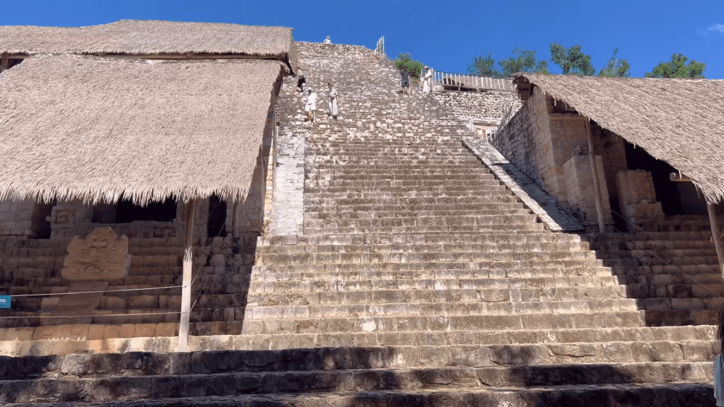 Climbing the stairs of the main pyramid Acropolis at Ek Balam ruins.