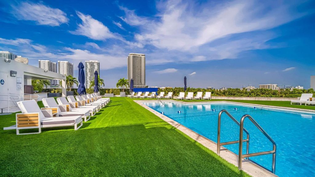 Family-friendly pool area at Hilton Miami Downtown with patio chairs for parents and space for kids to play.