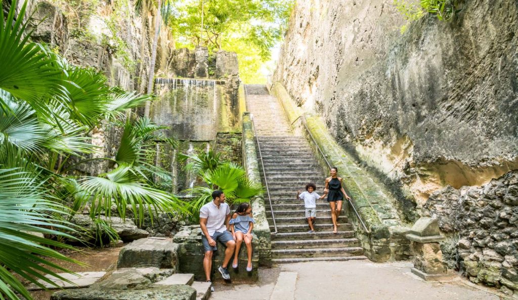 The Queen’s Staircase in Nassau, Bahamas, surrounded by lush tropical greenery, showcases the historic stone steps carved by enslaved people in the late 18th century.