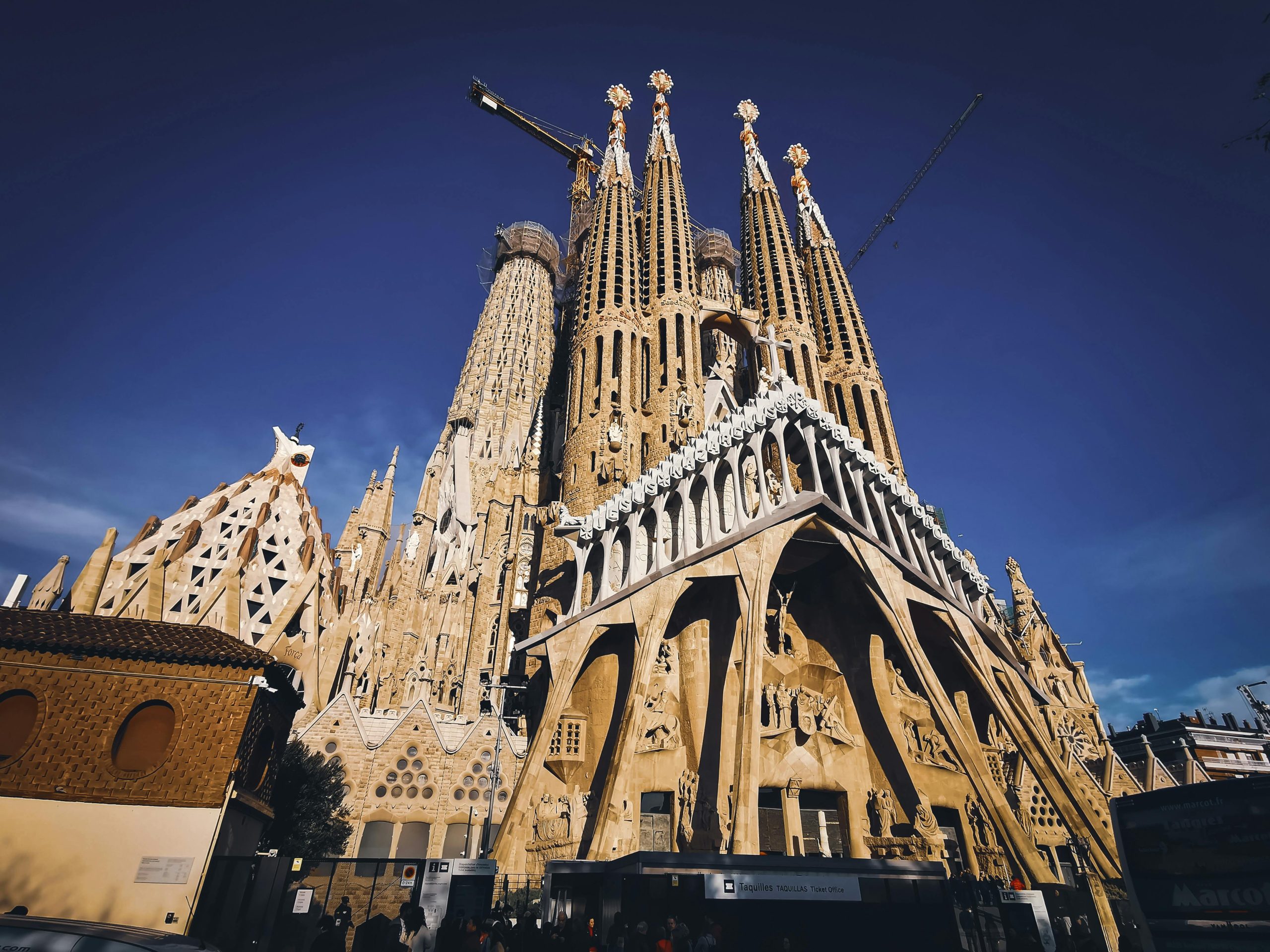 Low angle view of La Sagrada Família, the iconic basilica in Barcelona, showcasing its intricate architecture and towering spires.