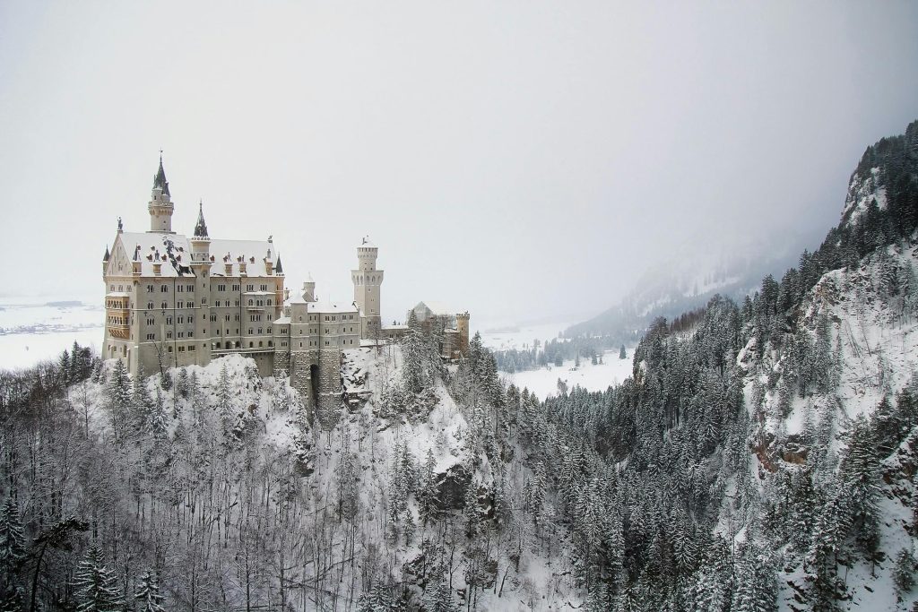 Schloss Neuschwanstein covered in snow during winter, showcasing its fairytale beauty in the Bavarian Alps.