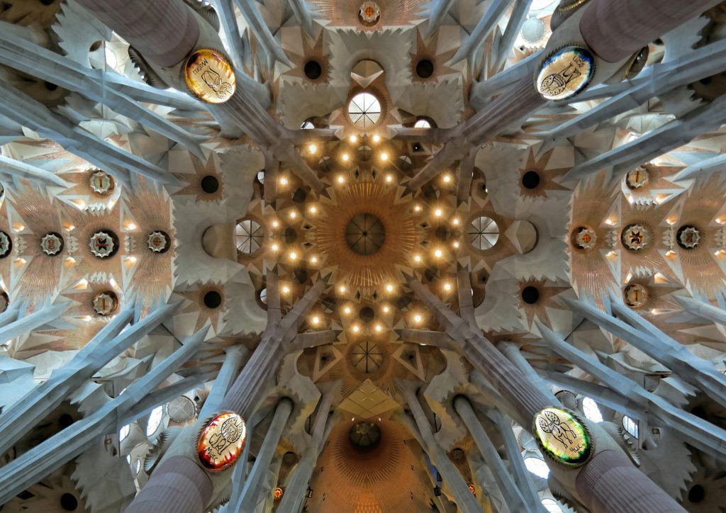 Intricate ceiling detail of the Sagrada Familia Basilica in Barcelona, showcasing Art Nouveau design.